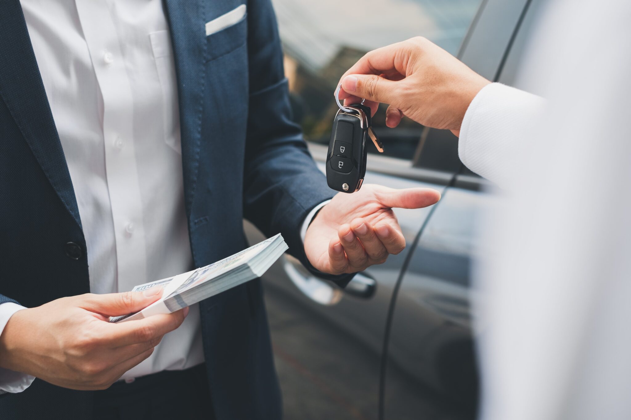 Car seller handing car keys to a customer